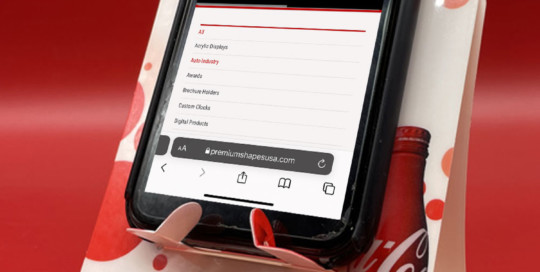 Coke PDA holder shown with phone