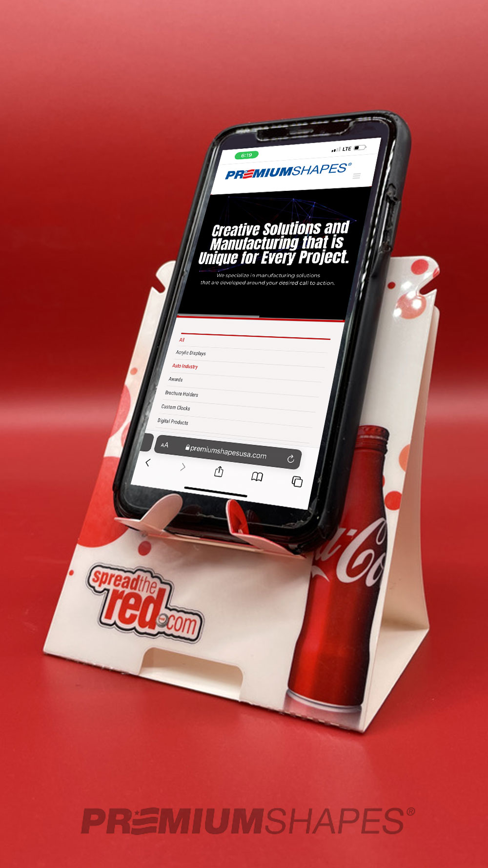 Coke PDA holder shown with phone